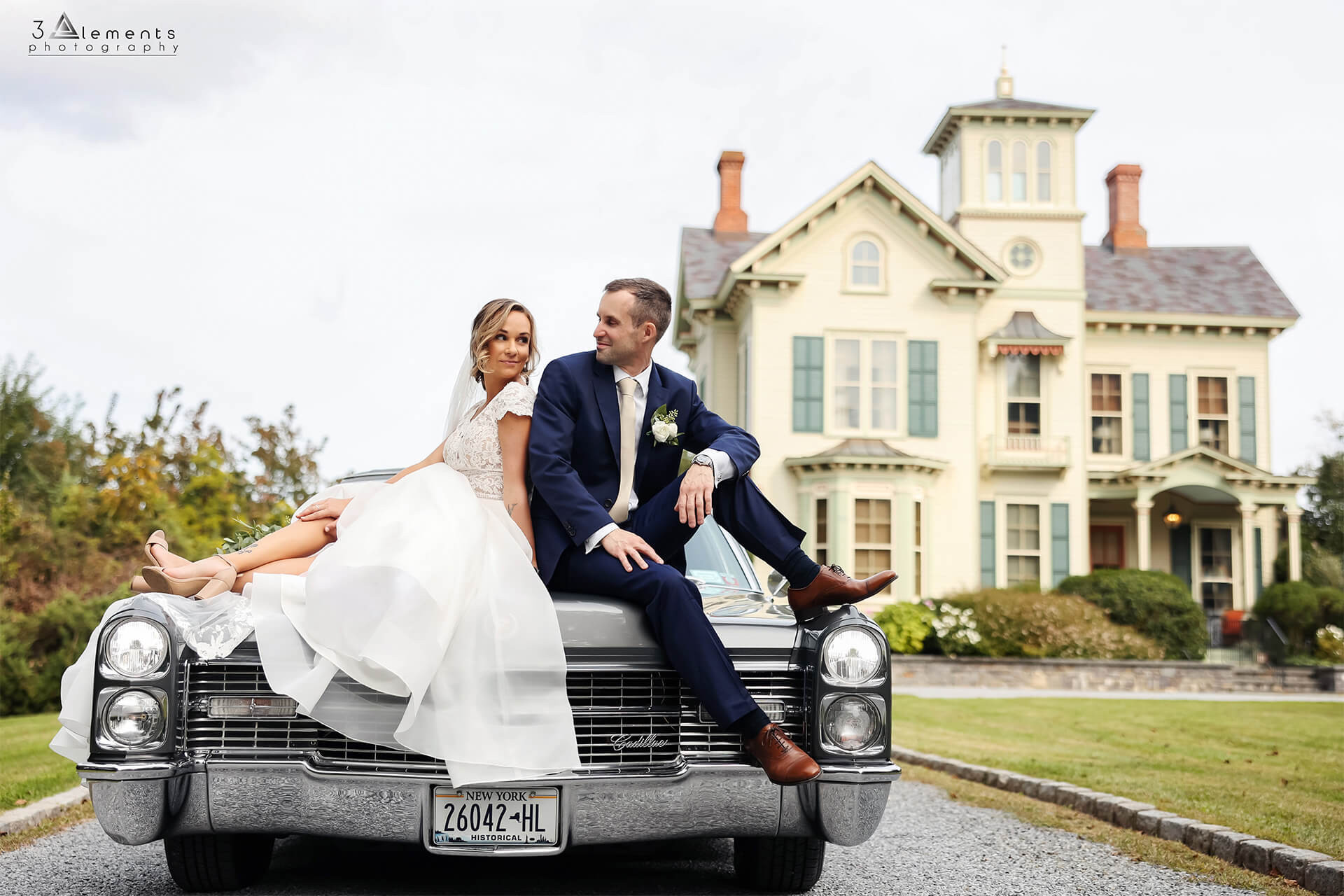 Bride and groom sitting on their truck in front of Jedediah Hawkins Inn - 3 Elements Photography